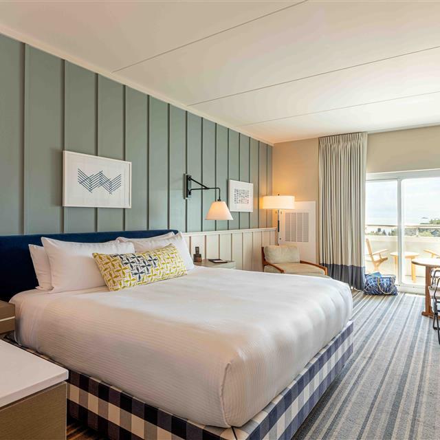 Bedroom with a single bed and a balcony