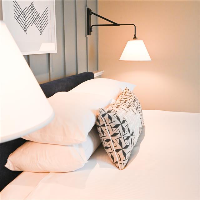Bedside detail with wall sconce
