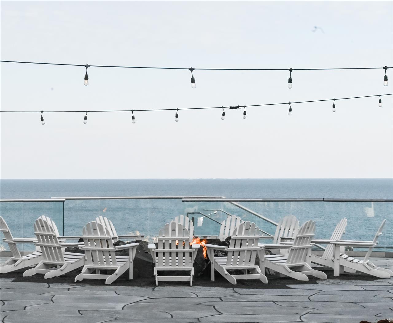 Outdoor seating area with patio chairs surrounding a fire pit
